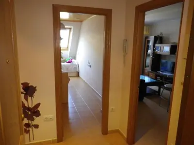 a hallway leading to a living room with a television at Ático a 5 minutos de TODO Mariña Lucense in Viveiro