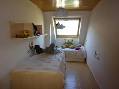 two teddy bears sitting on a bed in a bedroom at Ático a 5 minutos de TODO Mariña Lucense in Viveiro