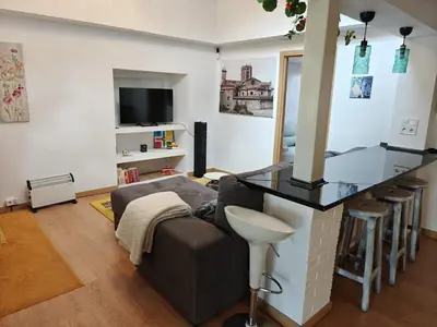a living room with a bar and a couch at Casa Diego in Melias