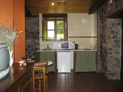 a kitchen with a sink and a counter top at Casa Pipa in Pola de Somiedo