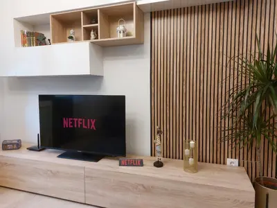 a flat screen tv sitting on top of a wooden table at Apartamento Puerta de San Fernando in Lugo