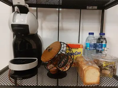 a coffee maker and bread on a shelf in a refrigerator at Apartamento Puerta de San Fernando in Lugo