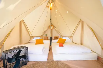 a tent with two beds in a room at O Pedrouzo Pilgrim Camp in O Pedrouzo