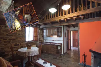 a large kitchen with a table and a ceiling at Apartamentos rurales Casa Do Cabo in Vega de Logares