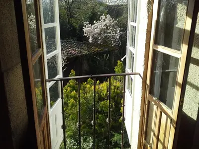 an open window with a view of a garden at Casa Grande De Trives in Puebla de Trives