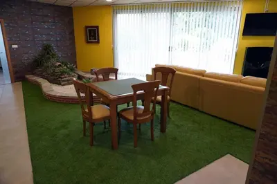 a living room with a table and chairs and a couch at Casa Ribeira Sacra in Chantada