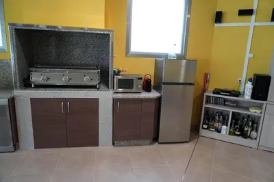a kitchen with a refrigerator and a microwave at Casa Ribeira Sacra in Chantada