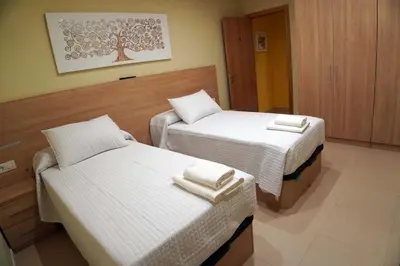 a bedroom with two beds with towels on them at Casa Ribeira Sacra in Chantada