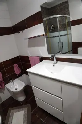 a bathroom with a white sink and a toilet at Casa Ribeira Sacra in Chantada