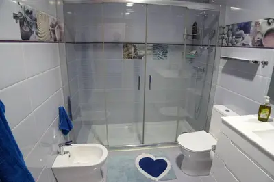 a bathroom with a shower and a toilet and a sink at Casa Ribeira Sacra in Chantada