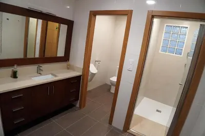 a bathroom with a sink and a toilet and a mirror at Casa Ribeira Sacra in Chantada