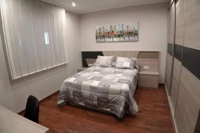 a small bedroom with a bed and a window at Casa Ribeira Sacra in Chantada