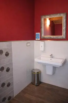 a bathroom with a sink and a mirror at Miraz Albergue O Abrigo