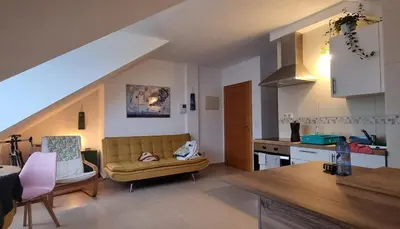a living room with a couch and a kitchen at Vila, 132 - II in San Cosme de Barreiros