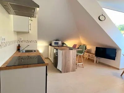 an attic kitchen with a sink and a counter top at Vila, 132 - II in San Cosme de Barreiros