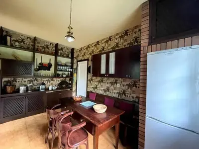 a kitchen with a wooden table and pink chairs at Spacious Villa with Pool in Cabeanca 250 m² in Ourense