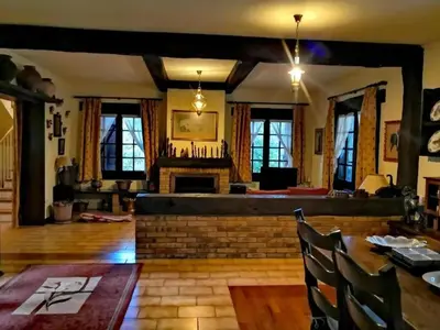 a living room with a fireplace and a table and chairs at Spacious Villa with Pool in Cabeanca 250 m² in Ourense