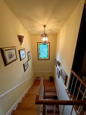 a staircase in a house with a chandelier at Spacious Villa with Pool in Cabeanca 250 m² in Ourense
