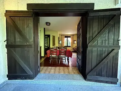 an open door leading into a dining room with a table at Spacious Villa with Pool in Cabeanca 250 m² in Ourense