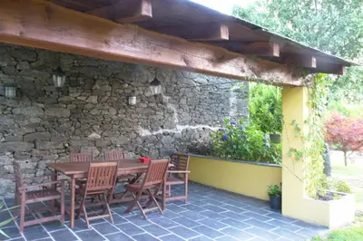 a wooden table and chairs on a patio at Casa de Arias in Parga
