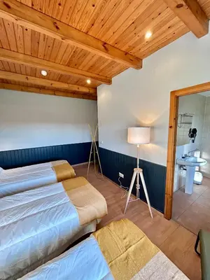 a large room with a table and a fireplace at Casa Bolboreta by Unusual Hotels in Palas de Rei