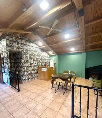 three beds in a room with a floral wall at Casa Bolboreta by Unusual Hotels in Palas de Rei