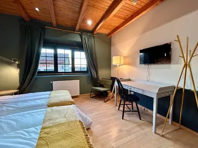 a bedroom with two beds and a lamp in it at Casa Bolboreta by Unusual Hotels in Palas de Rei