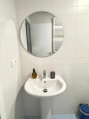 a bathroom with a mirror on a wall at Apartamento en Ares a 400 m de la playa con jardín privado in Ares