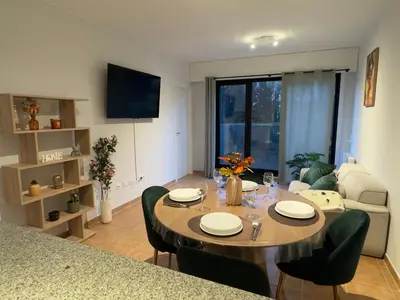 a living room with a table and a couch at Apartamento en Ares a 400 m de la playa con jardín privado in Ares