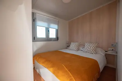 a bedroom with a large bed with a window at Balea House in Barreiros