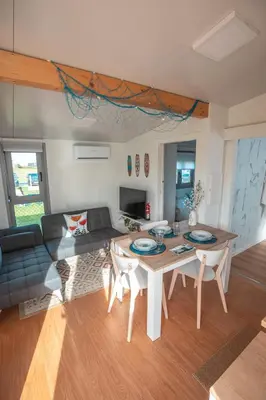 a living room with a table and a couch at Balea House in Barreiros