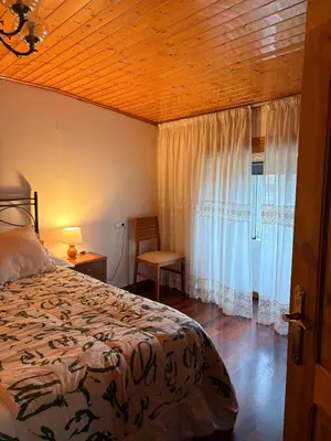 a bedroom with a bed and a window at Villa Tojo in Touro