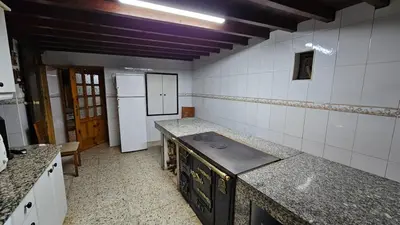 a kitchen with a stove top oven in a room at Villa Tojo in Touro