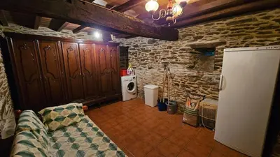 a living room with a couch and a refrigerator at Villa Tojo in Touro