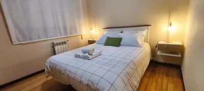 a bedroom with a white bed with two stuffed animals on it at Piso muy luminoso y céntrico 1D in Santiago de Compostela