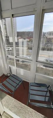 two chairs sitting in a room with windows at Piso muy luminoso y céntrico 1D in Santiago de Compostela