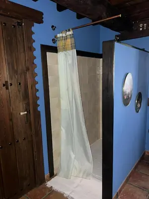 a bathroom with a shower with a shower curtain at Casa Rural Dorinda in Campelo