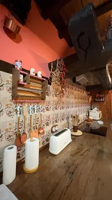 a kitchen with a wall with a counter with utensils at Casa Rural Dorinda in Campelo