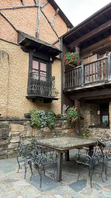 a table and chairs in front of a building at Casa Rural Dorinda in Campelo