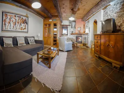 a living room with a couch and a tv at Casa Aurora in San Esteban del Toral