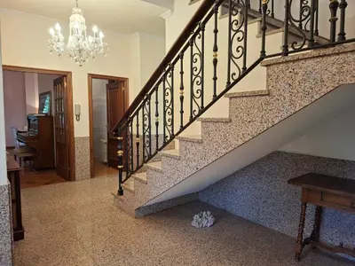 a staircase in a home with a chandelier at Oasis Ponte San Lázaro in Santiago de Compostela
