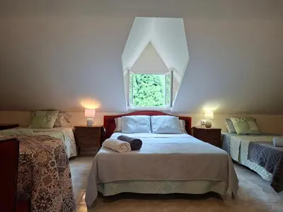a bedroom with two beds and a window at Oasis Ponte San Lázaro in Santiago de Compostela