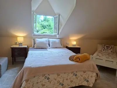 a bedroom with a large bed with a window at Oasis Ponte San Lázaro in Santiago de Compostela
