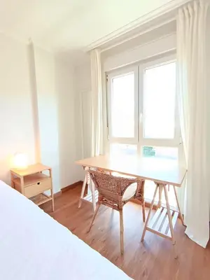 a desk in a room with a window and a bed at Alojamiento con vistas ría de Viveiro-Misericordia in Viveiro