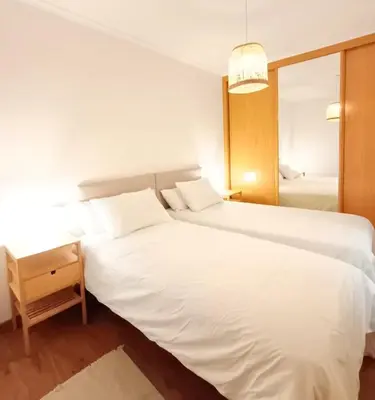 a hotel room with two beds and a table at Alojamiento con vistas ría de Viveiro-Misericordia in Viveiro
