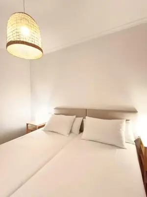 a bedroom with a large white bed with white pillows at Alojamiento con vistas ría de Viveiro-Misericordia in Viveiro