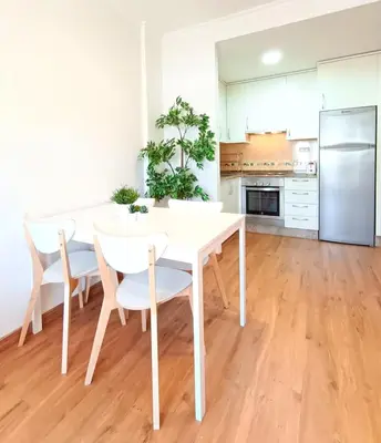 a kitchen with a white table and chairs at Alojamiento con vistas ría de Viveiro-Misericordia in Viveiro