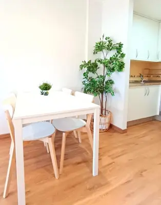 a white dining table and chairs in a kitchen at Alojamiento con vistas ría de Viveiro-Misericordia in Viveiro