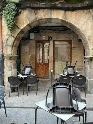 a group of tables and chairs in front of a building at Acogedor apartamento del Casco Antiguo de Ourense in Ourense