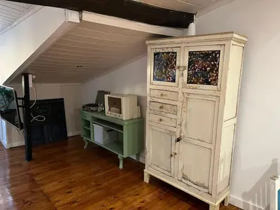 a room with an old cabinet and a desk at Acogedor apartamento del Casco Antiguo de Ourense in Ourense